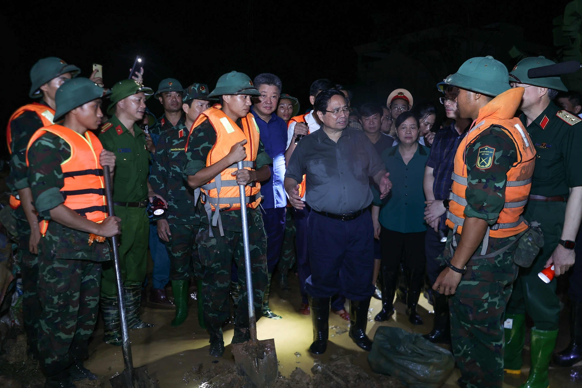 Thủ tướng động viên các lực lượng chức năng đang ứng phó với mưa lũ tại các xã Trung Giã, Đa Phúc. (Ảnh: VGP)