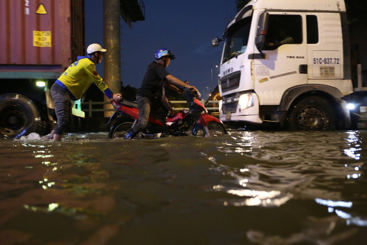Nước dâng cao trên đường Trần Xuân Soạn khiến nhiều xe máy khi lưu thông bị chết máy.
