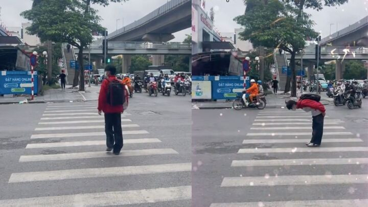 Hình ảnh nam sinh cúi đầu cảm ơn các tài xế dừng đèn đỏ khi sang đường. (Ảnh chụp màn hình)