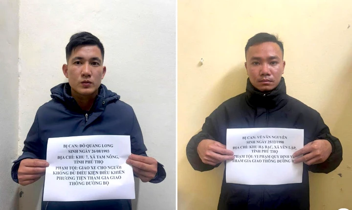 Đỗ Quang Long và Vũ Văn Nguyên tại cơ quan công an.