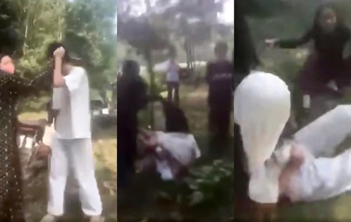 Hình ảnh nữ sinh áo trắng bị đánh hồi đồng, lột áo gây bất bình dư luận. (Ảnh cắt từ clip)