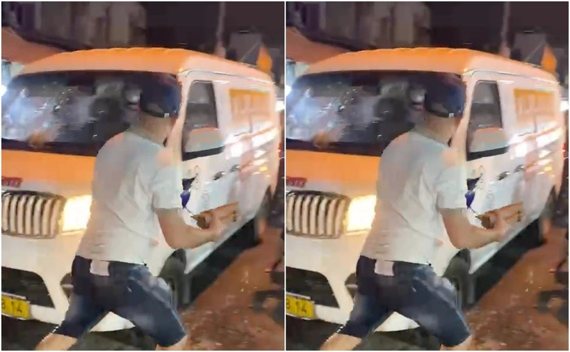 Hình ảnh người đàn ông cầm đá đập vào xe ô tô. (Ảnh: SGGP)