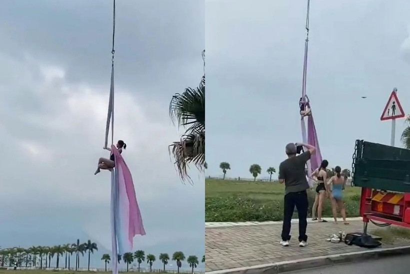 Một người phụ nữ mặc trang phục bó sát đang treo lơ lửng giữa không trung ở độ cao khoảng 5 mét bằng dây đai yoga. Ảnh: HK01.