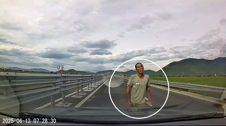 Thanh niên cầm đá dọa lái xe (ảnh cắt từ clip)