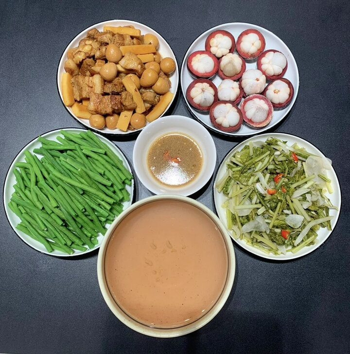 Thịt kho nước dừa ăn cùng dưa muối chua, rau luộc, tráng miệng với măng cụt.