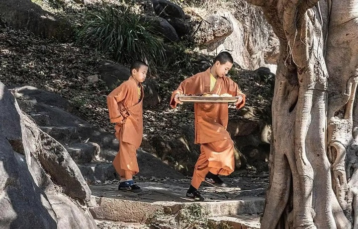 Một nhà sư trẻ mang khay thức ăn tại Thiếu Lâm Tự, nơi áp dụng chế độ ăn kiêng nghiêm ngặt chủ yếu là rau. (Ảnh: Baidu)