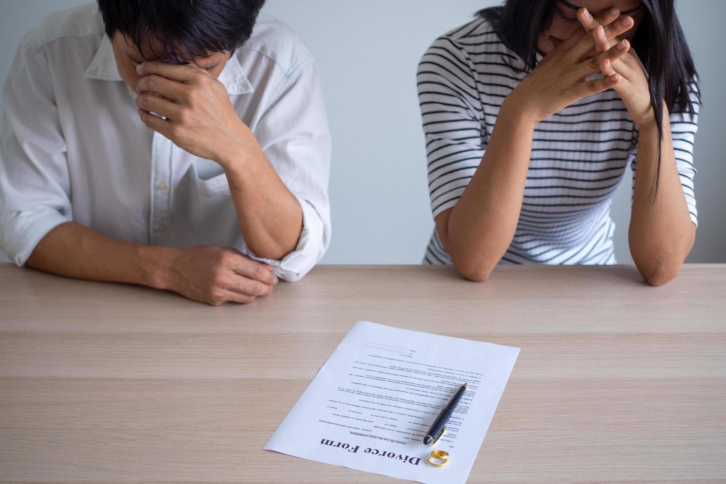 couple is feeling stressed after agreeing to sign a divorce certificate concepts of lovers having family problems divorce or quarrels or conflicts free photo.jpg