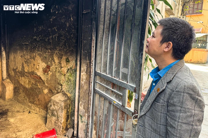 Anh N. cùng một người đàn ông phá khoá, dùng vòi xịt vào bên trong khu vực xảy ra cháy. (Ảnh: Viên Minh)