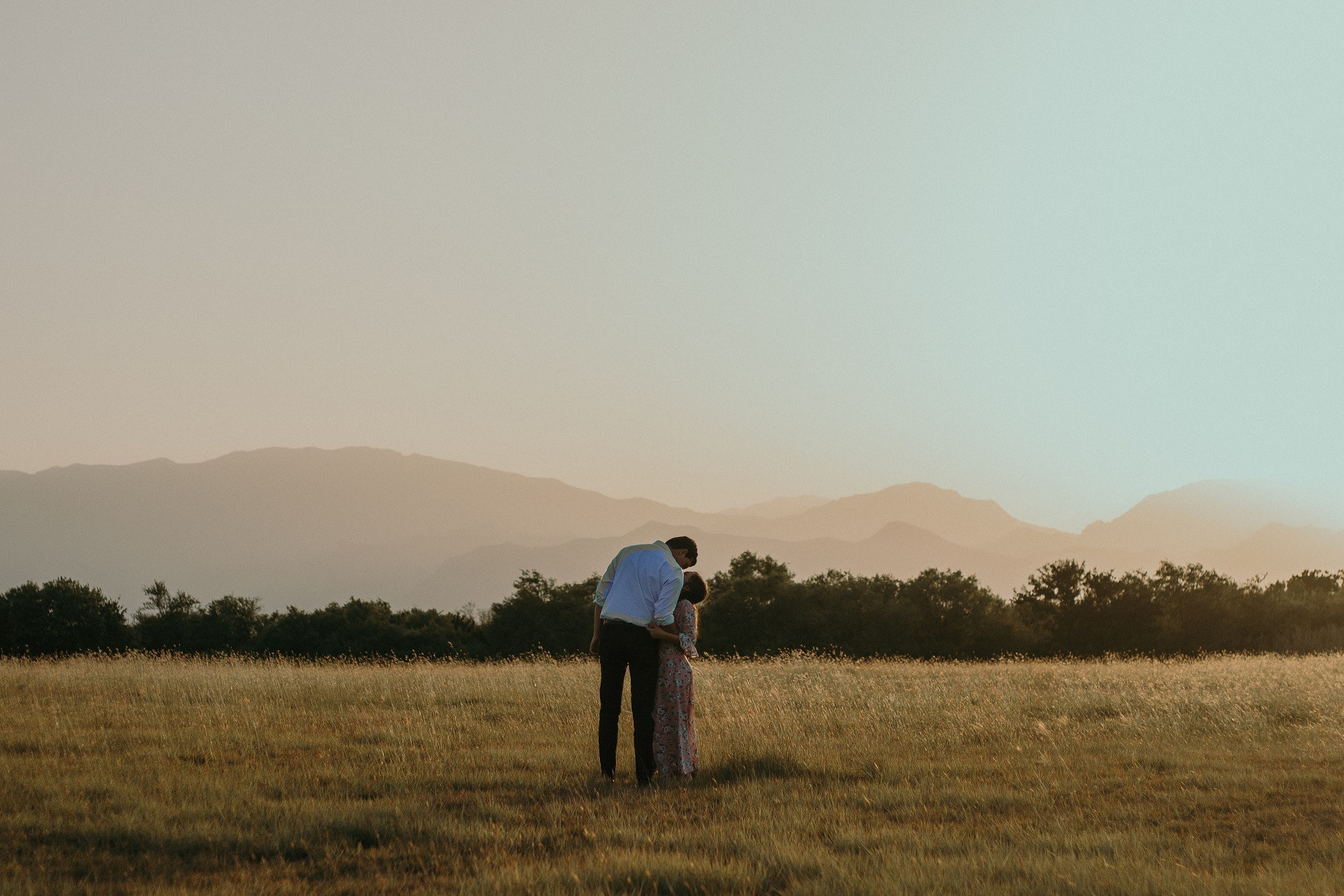 shot couple from back standing field kissing.jpg