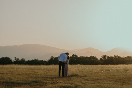 shot couple from back standing field kissing.jpg