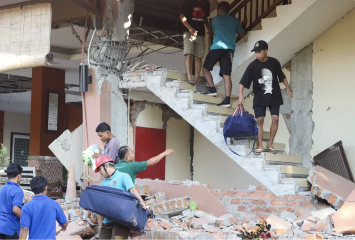 Người dân sơ tán khỏi tòa nhà bị sập sau trận động đất. (Ảnh: Reuters)